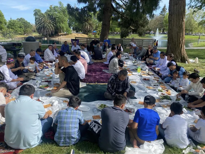 Volunteers and families sharing a community meal